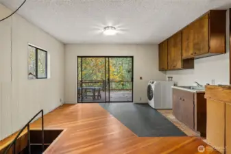 Laundry area w/spiral staircase keading to basement