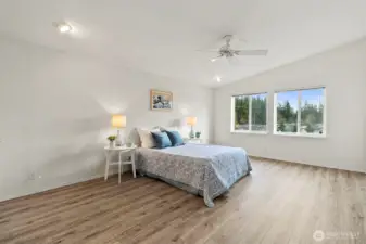 Promary bedroom with new floors and vaulted ceilings.