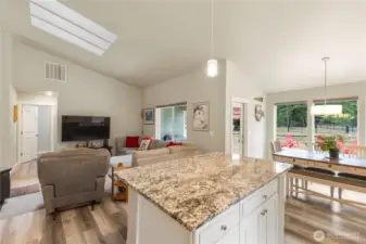 Kitchen island with eating space and additional cabinet storage.