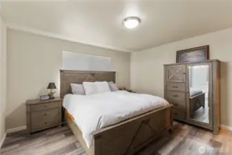 Primary bedroom with California king bedroom set plus a walk-in closet.