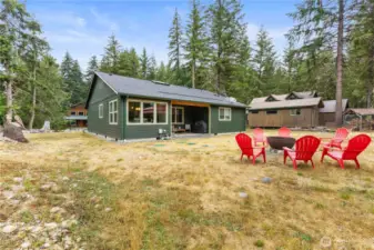 Dining room door leads out to a covered back patio. A great place to hang out rain or shine (or snow)!  11,250 SF lot with room to play. (Metal fire ring liner does not convey).