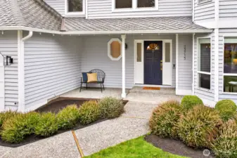 A sheltered front porch with an updated entry door and sidelights offers a practical, weather protected welcome, with Ring security features in place for added peace of mind.