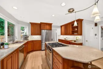 Designed for both efficiency and connection, the layout offers excellent counter space, generous cabinetry, and easy flow to the surrounding living areas, with updated switches and outlets for modern convenience.