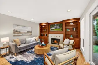 The adjacent family room features custom built ins and a cozy fireplace focal point, creating a comfortable everyday retreat that still feels elevated and intentional.