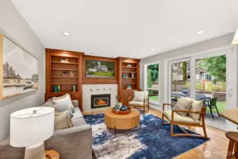 A spacious great room configuration pairs the warmth of built in cabinetry and fireplace ambiance with bright natural light and effortless access to the patio and backyard.
