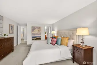 The primary suite is a true retreat, offering generous space, a calm color palette, and an easy connection to the private bath and walk in closet.