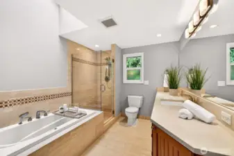 The primary bath feels spa inspired with a BainUltra heated air-jet hydrotherapy tub, a glass enclosed shower with timeless tilework, and a long vanity that makes mornings smoother.