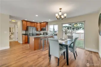 Dining space & kitchen with breakfast bar!  Down hall is bedroom. 3/4 bath located through doorway between kitchen & bedroom..