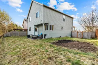 Large partially fenced backyard
