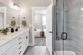 Great primary bath with double sink vanity, quartz counters, a nice tiled shower (notice the bench!) and tiled floors too.