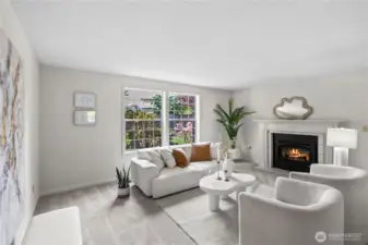 The living room welcomes you with large windows to let in the light.