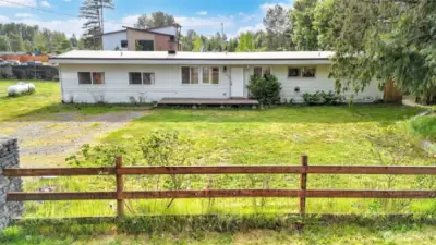 This darling rambler sits on a nearly half-acre lot on a quiet dead-end street, yet it is just minutes from local amenities, offering the perfect blend of comfort & convenience. Enjoy the spacious living room w/open sight lines to the kitchen. The kitchen boasts SS appliances, & a quaint dining space w/easy access to the backyard for indoor outdoor living. Cozy up to the cozy wood-burning fireplace, enjoy hardwood floors throughout most of the home, plus 3 generously sized guest bedrooms. Retreat to the massive primary w/a W/I closet, & an updated bath. Fully fenced lot providing ample space for outdoor activities, gardening & future expansion. Conveniently located near shops, dining, local businesses & easy freeway access.