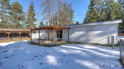 Step outside to the covered back patio overlooking the large backyard.