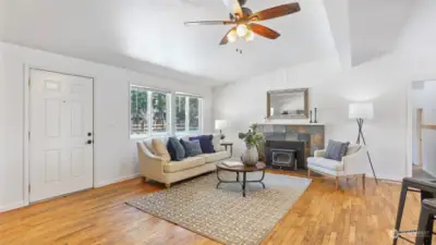 This living space offers vaulted ceilings, light and bright interiors and a cozy wood-burning fireplace.