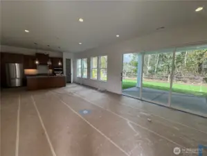 Kitchen and Great room with lots of windows and slider to covered patio.