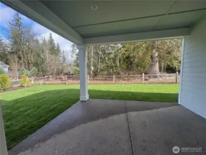 Covered patio and backyard facing private protected greenbelt