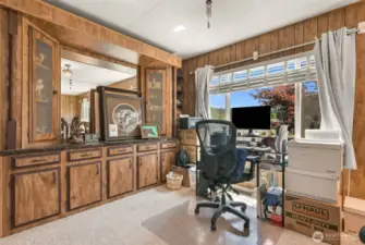 Built in china cabinet and office space that looks out on landscaping.