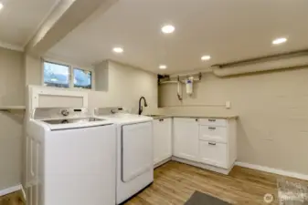 You have a laundry sink, custom cabinets wiht a lazy susan for full storage, a whole house water filtration system and washer and dryer stay!