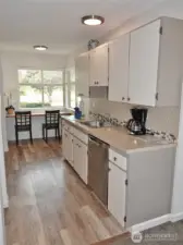 Fully-equipped Kitchen w/ laminate flooring.