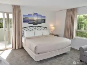 Main Bedroom w/ king-sized bed and lots of natural light.