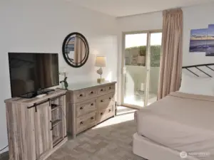 Main Bedroom w/ updated furniture and a slider to the Front Patio.