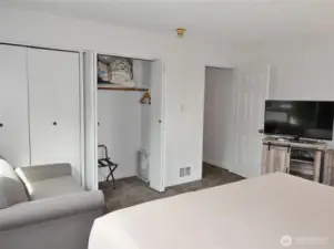 Main Bedroom w/ small loveseat.