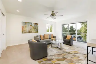 Upper level third bedroom or family room features balcony.