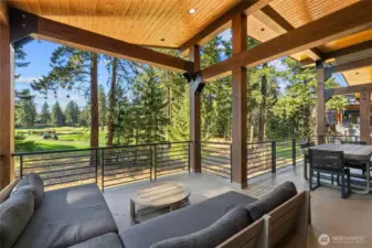 Sleek metal railings frame incredible views from the upper level deck.