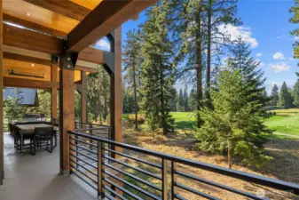 The upper level deck overlooks manicured fairways and mountain backdrops.