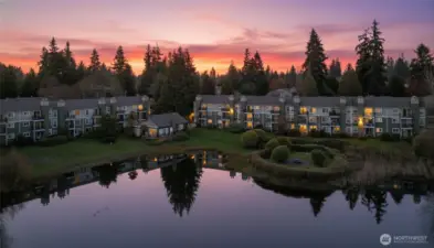 twilight drone shot of condos from across the lake