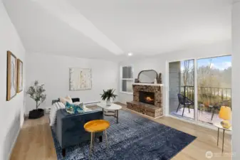 Living room w/ new LVP flooring throughout, wood burning fireplace