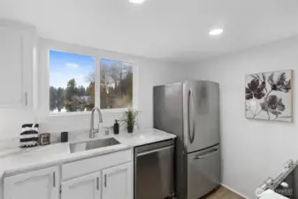 updated kitchen with all brand new appliances, quartzite countertops and freshly painted cabinets with new hardware