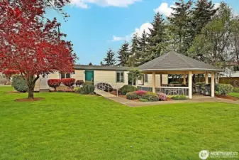View of the back of the Club House showing the grounds and outdoor barbeque area.