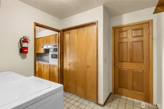 Laundry, closet and door to garage