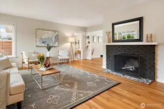 The wood fireplace is a centerpiece of the living room. Next to the chimney is the gas furnace, so potential retrofit made easier with the proximity to the piping.