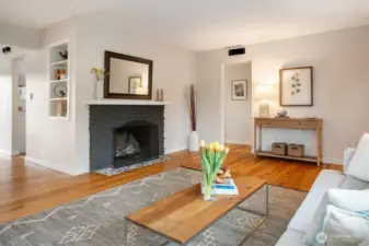 Right of the fireplace, the entry takes you to the 3 bedrooms on the north side of the home. To the left of the fireplace, the flow of the home goes to the dining space and to the kitchen. Let's go.