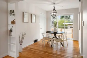The dining space with a large picture window facing west and overlooking the fenced in backyard. Cute built-ins add style to this 1950s home.