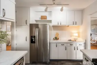 Nearly forgot to brag about the rest of the kitchen. Additional storage and counter space. Left of the refrigerator, the two cabinets offer great pantry and cleaning supplies space.
