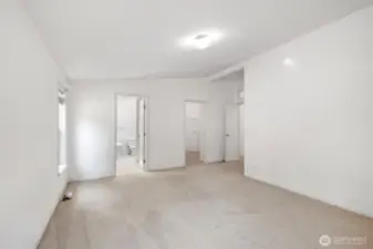 Primary bedroom with view to bathroom and walk-in closet