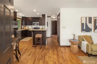 The main floor has an open-plan living/dining/kitchen area, two large bedrooms, and a full bathroom.