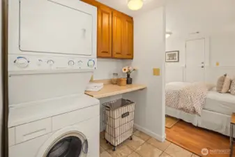 The laundry room is located off of the downstairs bedroom, and separated from the stairwell by a locking door.
