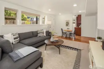 The downstairs living room, looking into the kitchen. The door onto the patio visible in the third photo is the entrance door here.