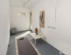 The bonus room! The door at the far end of the photo opens out onto the patio by the entrance to the basement apartment.