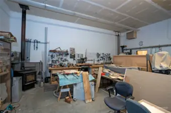 Detached garage/shop, complete with a wood-stove for keeping cozy during chilly days while you work diligently. Ample space to unleash your creativity!