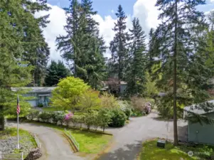 As you drive up the shared private driveway, you're warmly welcomed by this exceptional home.