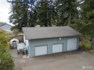 The detached garage/shop boasts not only two standard garage doors but also an extra-large third door, measuring 10 feet, perfect for RV parking.