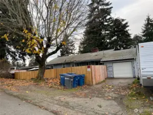 Front of home with fully fenced front yard and RV parking