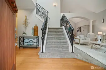 Grand entrance with wrought iron staircase.