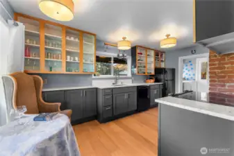 Recently updated kitchen with fabulous quartz counters, contemporary cabinets and new flooring! Kitchen with a vivid personality.