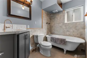 Newly tiled bathroom with clawfoot bathtub-shower and quart corner sink!